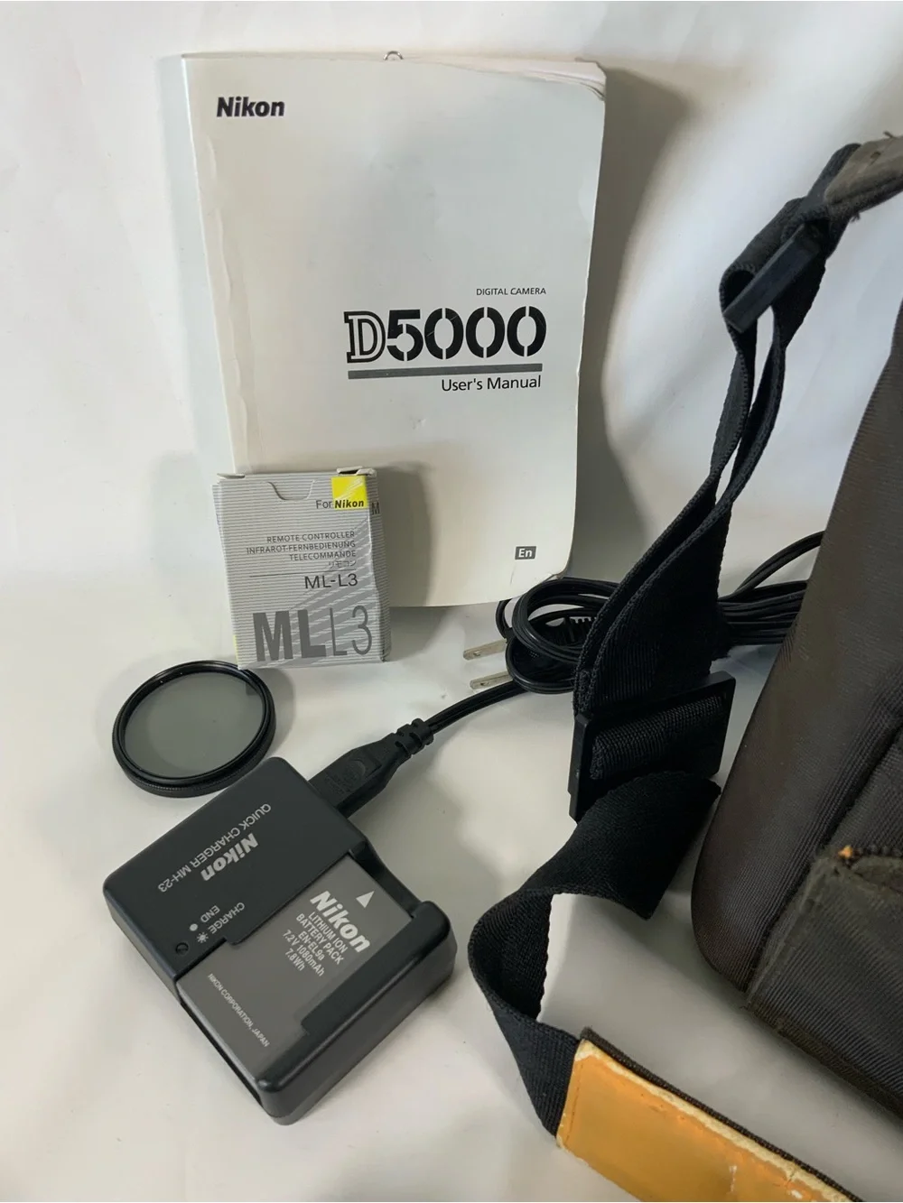 Nikon DSLR Camera with Black Body and Yellow-Orange Interior Bag